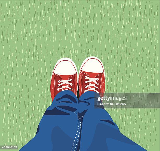 sneakers on the grass - jeans vector stock illustrations