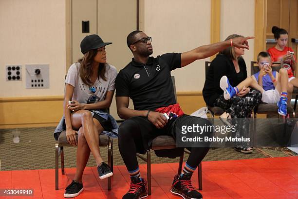 Gabrielle Union and Dwyane Wade enjoy the games at Dwyane Wade Fourth Annual Fantasy Basketball Camp at Westin Diplomat on August 1, 2014 in...