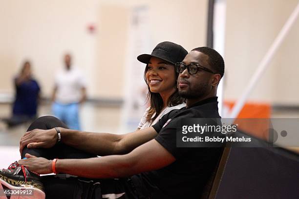 Gabrielle Union and Dwyane Wade enjoy the games at Dwyane Wade Fourth Annual Fantasy Basketball Camp at Westin Diplomat on August 1, 2014 in...