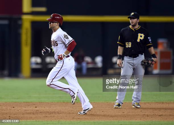 Brent Morel of the Pittsburgh Pirates watches Ender Inciarte of the Arizona Diamondbacks round the bases after hitting a three run home run during...