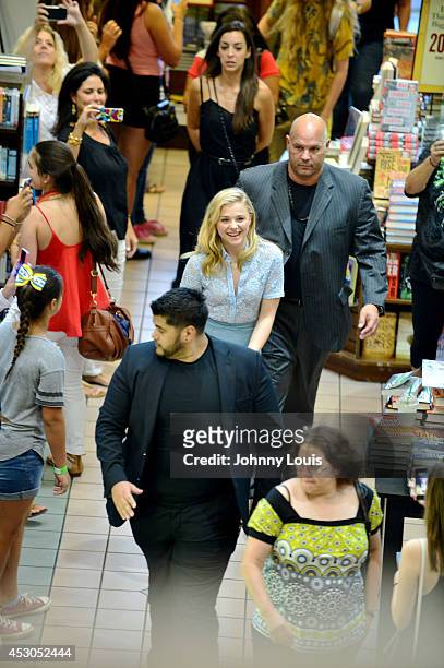 Chloe Grace Moretz walk in among a crowd of fans awaiting for her to signs copies of the book "If I Stay" at Barnes & Noble Booksellers on August 1,...