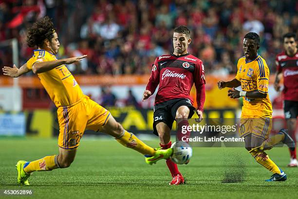 Antonio Briseno of Tigres tries to block a shot of Greg Garza of Xolos during a match between Tijuana and Tigres UANL as part of 3rd round Apertura...