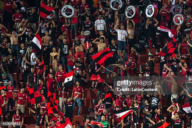 Fans of Xolos cheer on their team during a match between Tijuana and Tigres UANL as part of 3rd round Apertura 2014 Liga MX at Caliente Stadium on...