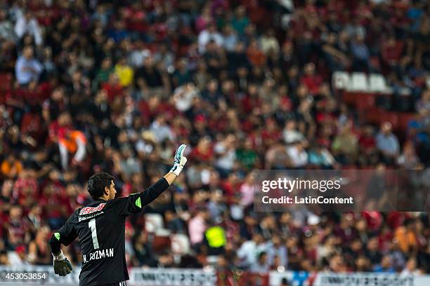 Nahuel Guzman of Tigres rise his arm during a match between Tijuana and Tigres UANL as part of 3rd round Apertura 2014 Liga MX at Caliente Stadium on...