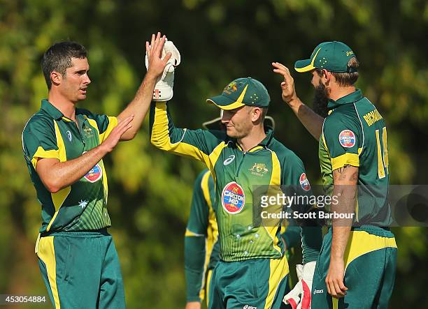 Ben Cutting of Australia 'A' is congratulated by Peter Nevill and Kane Richardson after dismissing Manoj Tiwary of India 'A' during the Cricket...