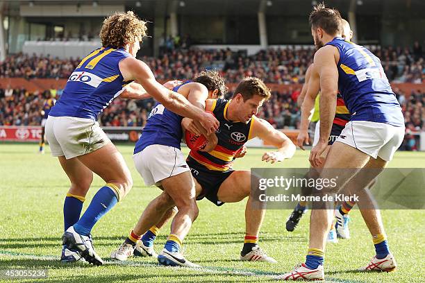 Matthew Wright of the Crows is tackled during the round 19 AFL match between the Adelaide Crows and the West Coast Eagles at Adelaide Oval on August...