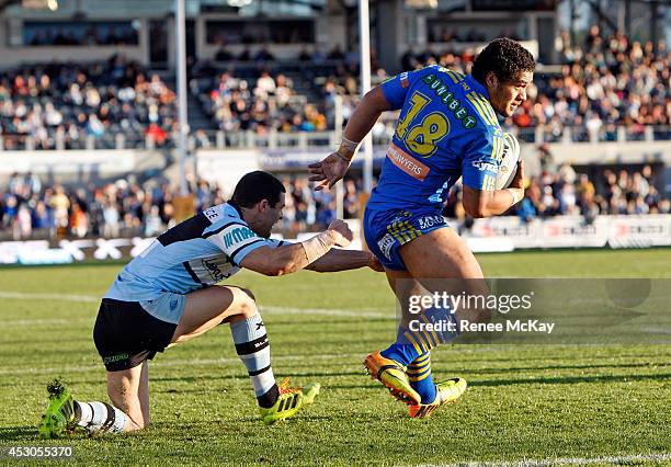 Bureta Faraimo of the Eels breaks away from Michael Gordon of the Sharks during the round 21 NRL match between the Cronulla Sharks and the Parramatta...