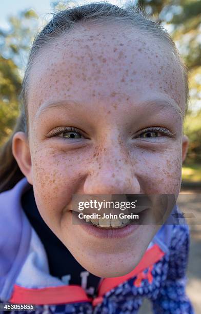 Smiling tween girl poses for a selfie.