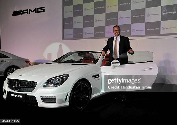 Managing Director and CEO Mercedes-Benz India Eberhard Kern poses with SLK 55 AMG during its launch on December 2, 2013 in New Delhi, India. The...