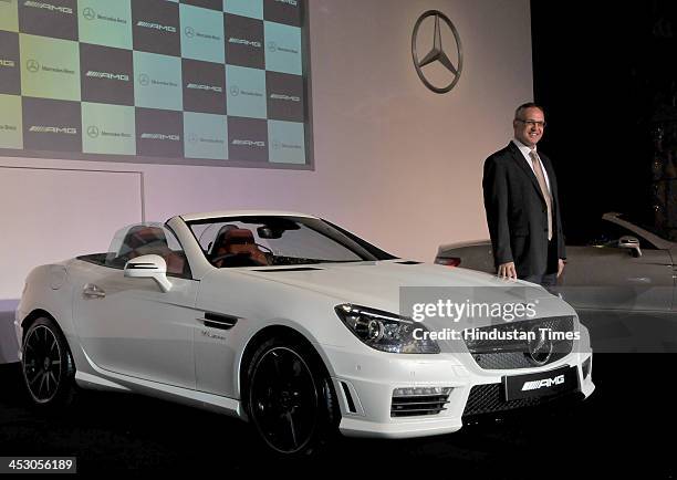 Managing Director and CEO Mercedes-Benz India Eberhard Kern poses with SLK 55 AMG during its launch on December 2, 2013 in New Delhi, India. The...