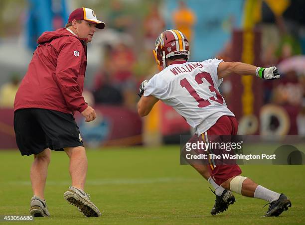 Washington head coach Jay Gruden, left, covers wide receiver Nick Williams on a passing route during day 9 of the Washington Redskins training camp...