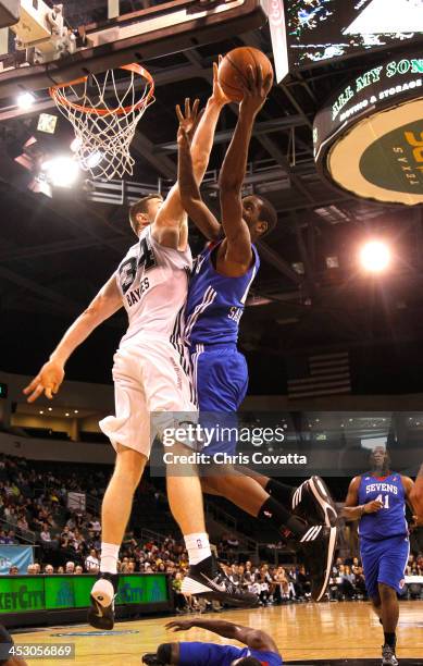 Damian Saunders of the Delaware 87ers shoots while driving against Aron Baynes of the Austin Toros on December 1, 2013 at the Cedar Park Center in...