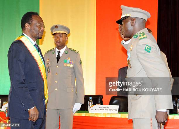 Dioncounda Traore , the former parliament speaker receives a salute from junta leader captain Amadou Sanogo during his swearing in ceremony as Mali's...