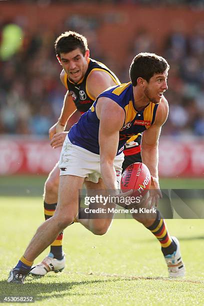 Patrick McGinnity of the Eagles runs with the ball during the round 19 AFL match between the Adelaide Crows and the West Coast Eagles at Adelaide...