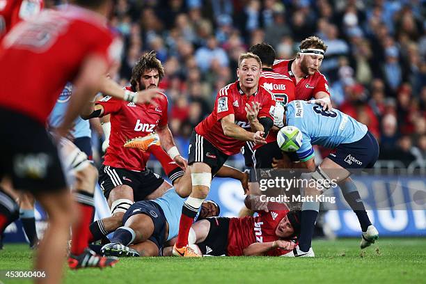 Andy Ellis of the Crusaders passes during the Super Rugby Grand Final match between the Waratahs and the Crusaders at ANZ Stadium on August 2, 2014...
