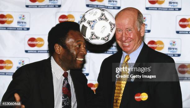 Pele and Bobby Charlton pose with a match ball for a picture during EURO '96.