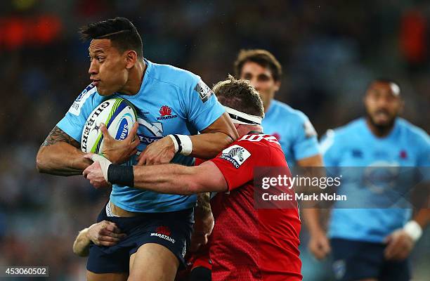 Israel Folau of the Waratahs is tackled during the Super Rugby Grand Final match between the Waratahs and the Crusaders at ANZ Stadium on August 2,...