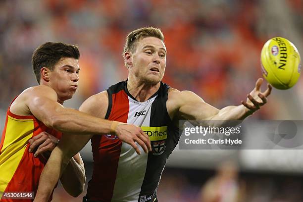 Jaeger O'Meara of the Suns and David Armitage of the Saints compete for the ball during the round 19 AFL match between the Gold Coast Suns and the St...