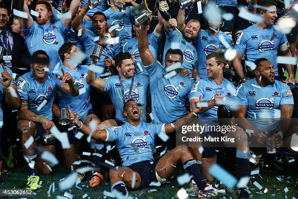 Kurtley Beale and Waratahs players celebrate victory and hold the Super Rugby trophy during the Super Rugby Grand Final match between the Waratahs...