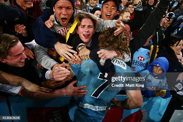 Michael Hooper of the Waratahs celebrates victory with fans at the end of during the Super Rugby Grand Final match between the Waratahs and the...