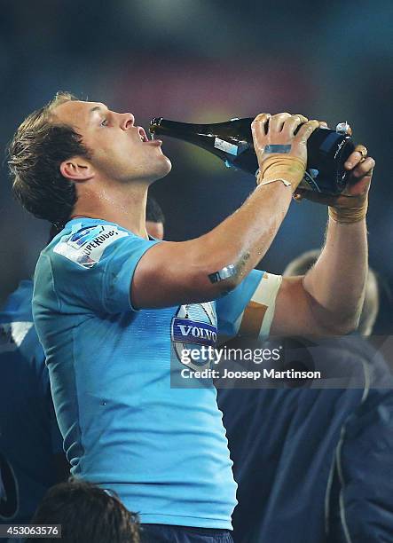 Stephen Hoiles of the Waratahs drinks shampagne after the Super Rugby Grand Final match between the Waratahs and the Crusaders at ANZ Stadium on...