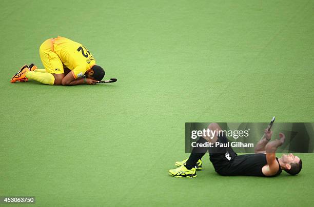 Raghunath Ramachandra of India celebrates winning as Phil Burrows of New Zealand looks dejected in the Men's Semi-Final match between New Zealand and...