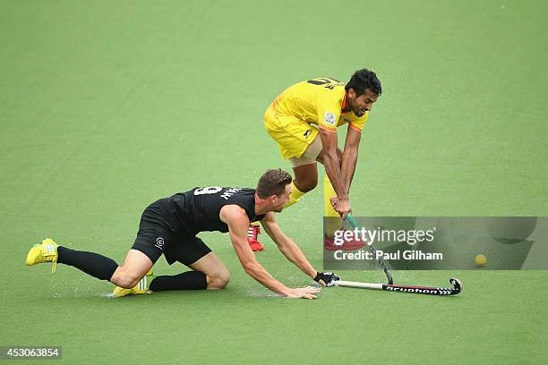 Dharamvir Singh of India battles for the ball with Alex Shaw of New Zealand during the Men's Semi-Final match between New Zealand and India at...