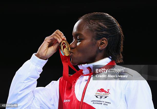 Gold medalist Nicola Adams of England kisses her medal during the medal ceremony for the Women's Fly Final at SSE Hydro during day ten of the Glasgow...