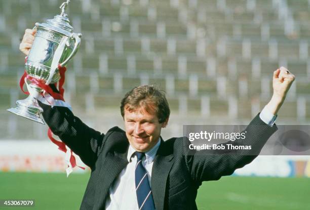 Aberdeen F.C. Manager Alex Ferguson raises the trophy after his team won the Scottish Cup final against Rangers F.C. At Hampden Park, Glasgow, 22nd...