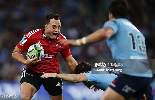Israel Dagg of the Crusaders takes on the defence during the Super Rugby Grand Final match between the Waratahs and the Crusaders at ANZ Stadium on...