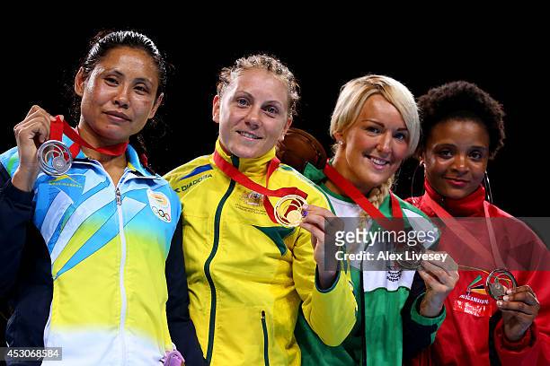 Gold medalist Shelley Watts of Australia poses with silver Laishram Devi of India and bronze medalists Alanna Audley-Murphy of Northern Ireland and...