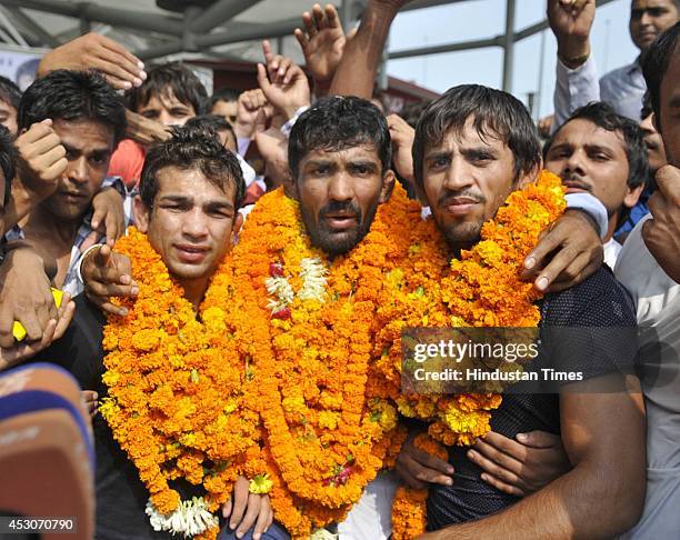 India wrestlers Amit Kumar , Yogeshwar Dutt and Bajrang after arriving from the Commonwealth games in Glasgow, at IGI Airport on August 2, 2014 in...