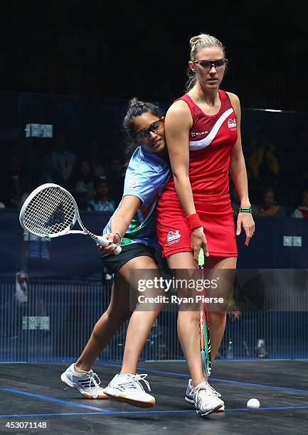 Dipika Pallikal of India is blocked by Laura Massaro of England during the Squash Women's Doubles Final between England and India at Scotstoun Sports...