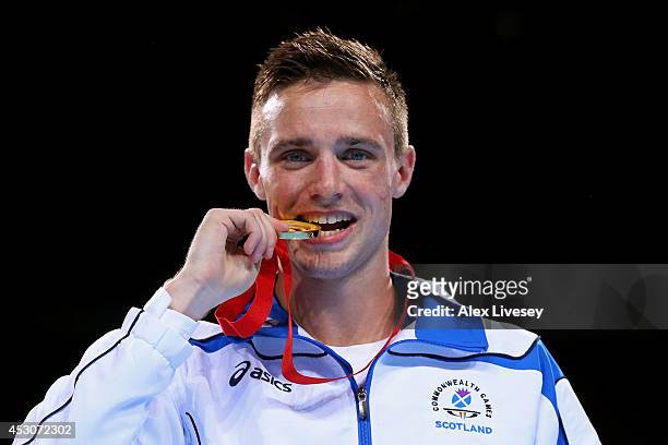 Gold medalist Josh Taylor of Scotland poses during the medal ceremony for the Men's Light Welter Final at SSE Hydro during day ten of the Glasgow...