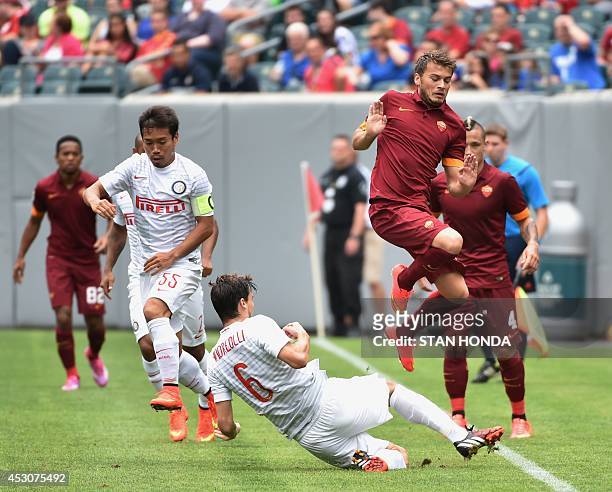 Adem Ljajic of AS Roma jumps over Marco Andreolli of Inter Milan during group play in the Guinness International Champions Cup on August 2, 2014 at...