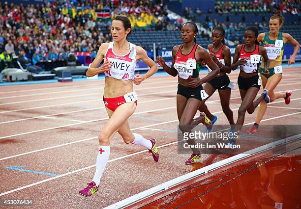 Jo Pavey of England and Mercy Cherono of Kenya lead the pack in the Women's 5000 metres final at Hampden Park during day ten of the Glasgow 2014...