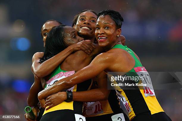 Christine Day, Novlene Williams-Mills of Jamaica, Anastasia le-Roy and Stephanie McPherson of Jamaica celebrate winning gold in the Women's 4x400...