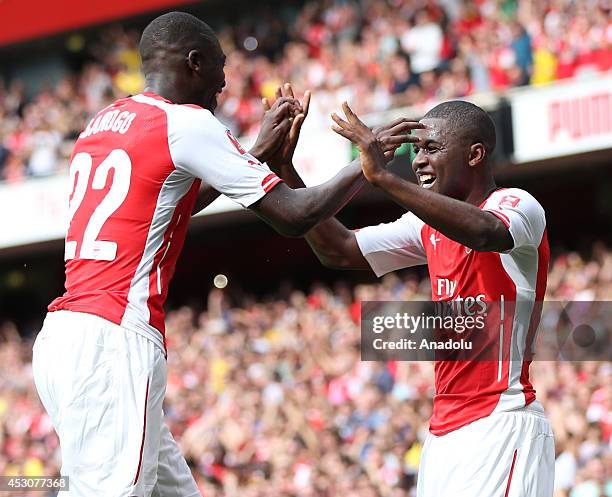 Yaya Sanogo of Arsenal celebrate his goal with his teammate during the Emirates Cup 2014 soccer match between Arsenal and Benfica at the Emirates...