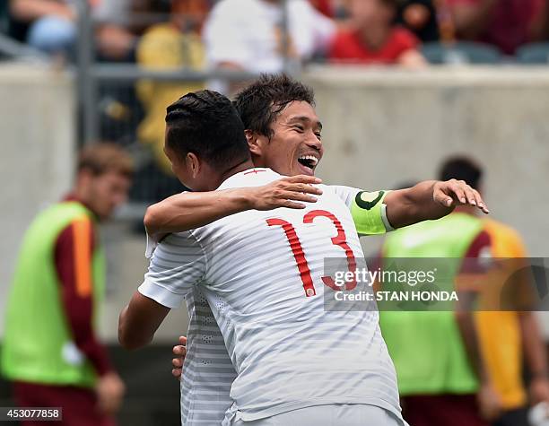 Yuto Nagatomo of Inter Milan celebrates his second half goal against AS Roma with teammate Fredy Guarín during group play in the Guinness...