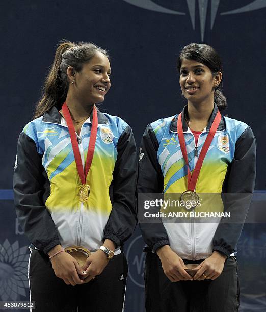 Gold medalists Dipika Pallikal of India and Joshana Chinappa of India pose on the podium with their medals after winning the women's gold medal match...