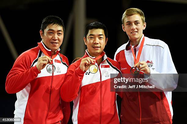 Gold medalist Jian Zhan of Singapore poses with silver medalist Ning Gao of Singapore of Singapore and bronze medalist Liam Pitchford of England...