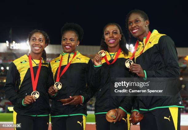 Gold medalists Shelly-ann Fraser-Pryce, Schillonie Calvert Veronica Campbell-Brown and Kerron Stewart of Jamaica pose on the podium during the medal...