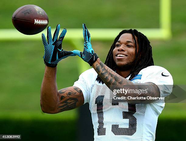 Carolina Panthers wide receiver Kelvin Benjamin smiles as he catches passes while warming up for practice on Saturday, Aug. 2 at Gibbs Stadium on the...