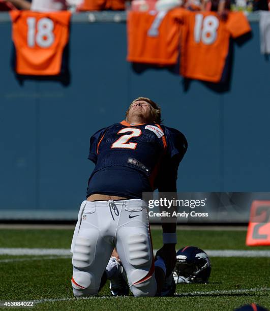 Denver Broncos QB, Zac Dysert, stretches before practice and scrimmage at Sports Authority Field at Mile High Saturday afternoon, August 02, 2014.