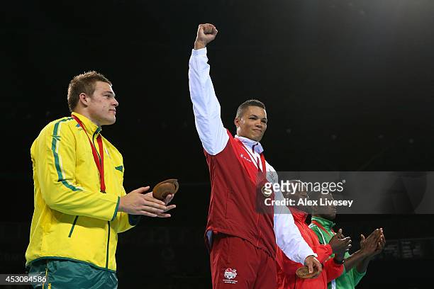 Gold medalist Joseph Joyce of England poses with silver medalist Joseph Goodall of Australia and bronze medalists Mike Sekabembe of Uganda and Efe...