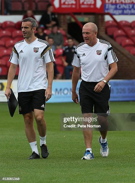 Brentford manager Mark Warburton and assistant David Weir walk to the bench prior to the Pre Season Friendly match between Brentford and Crystal...