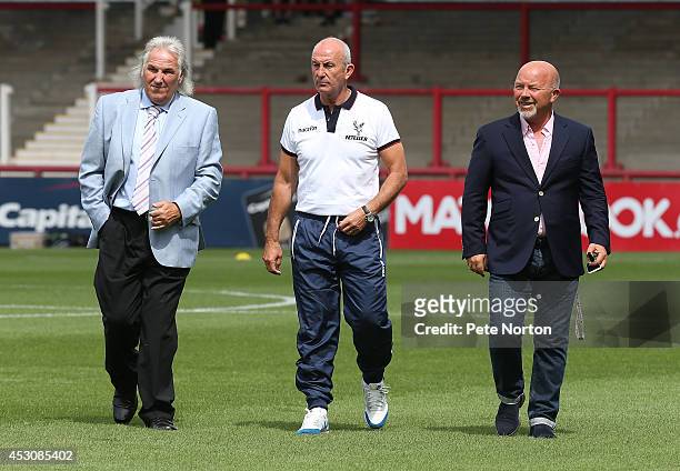 Crystal Palace manager Tony Pulis walks with coach Gerry Francis and Brentford's sporting director Frank McParland prior to the Pre Season Friendly...