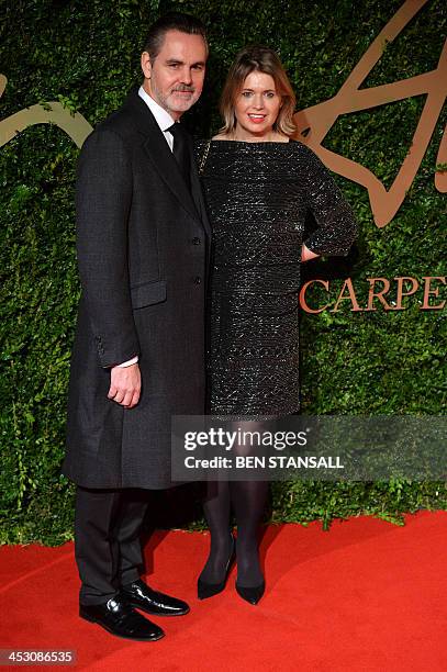 British fashion designer Jenny Packham and husband Matthew Anderson pose on the red carpet as they arrive for the British Fashion Awards in London on...