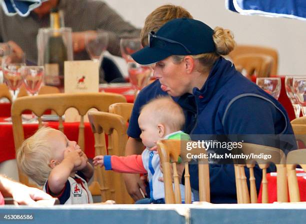 Zara Phillips, with daughter Mia Tindall, jokes with her niece Isla Phillips as she attends day 2 of the Festival of British Eventing at Gatcombe...