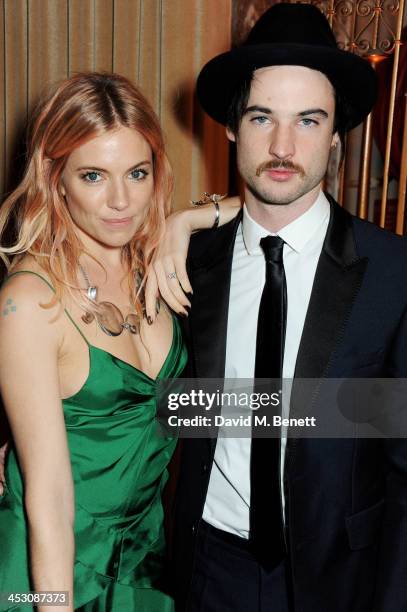 Sienna Miller and Tom Sturridge attend the British Fashion Awards 2013 drinks reception at the London Coliseum on December 2, 2013 in London, England.